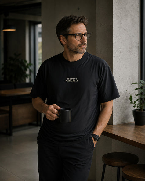 Male model wearing the Shevelo Resolve manually heavyweight oversized tee in Faded black.