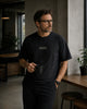 Male model wearing the Shevelo Resolve manually heavyweight oversized tee in Faded black.