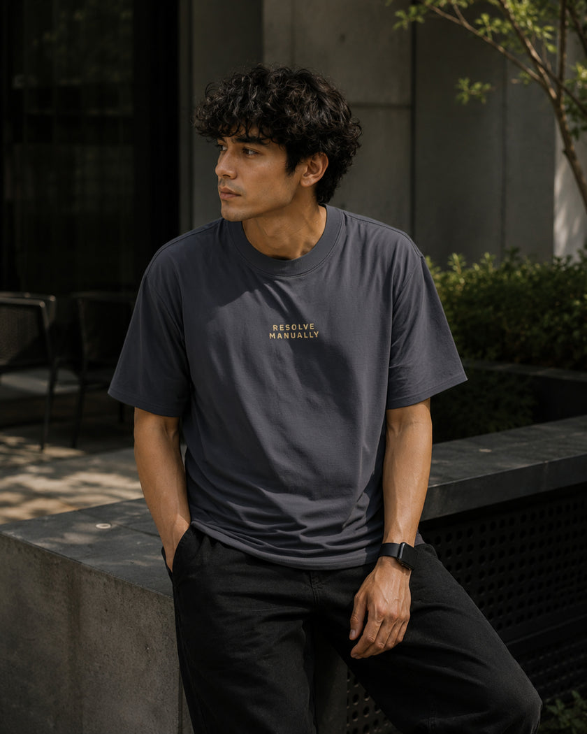 Male model wearing the Shevelo Resolve manually heavyweight oversized tee in Faded indigo.