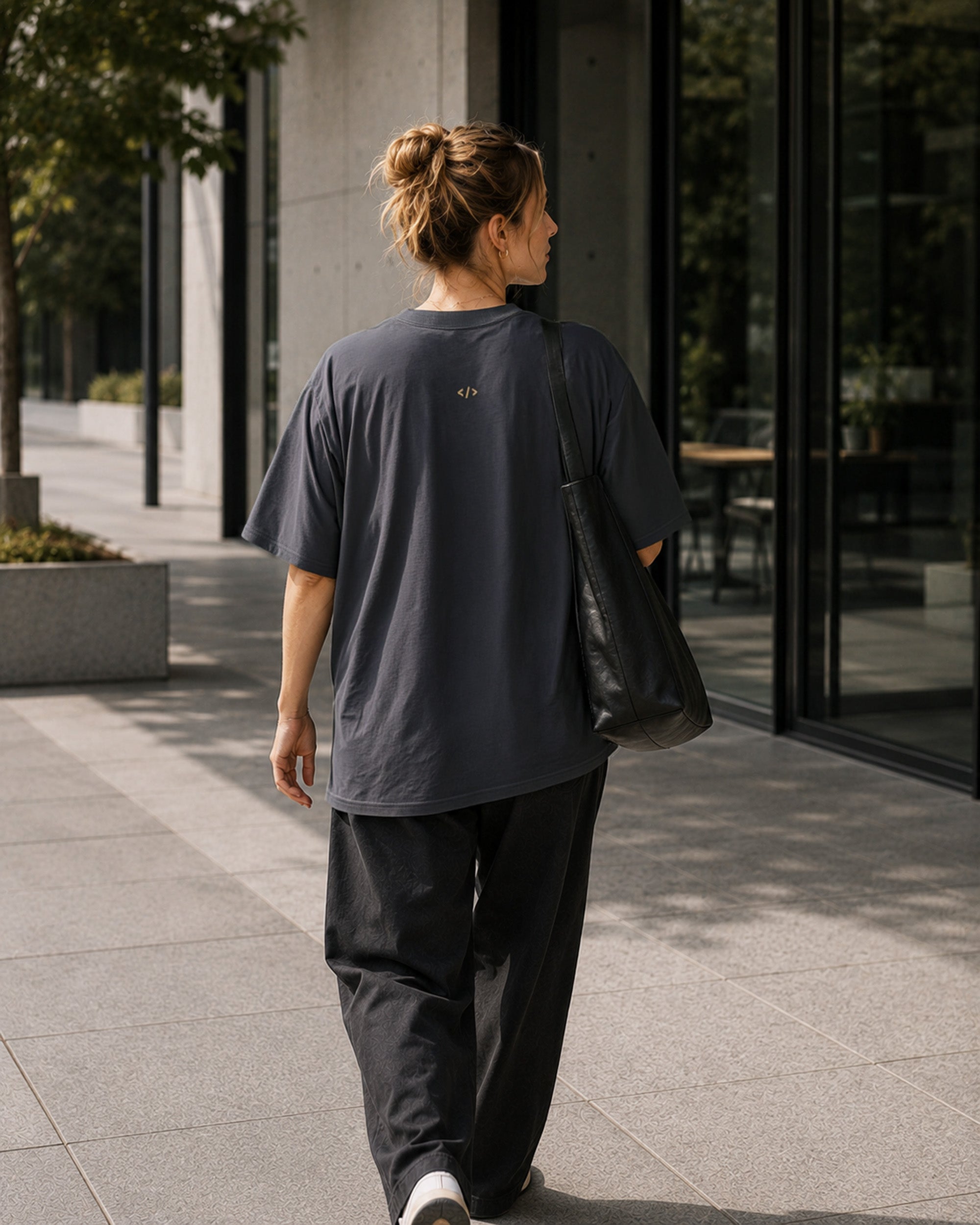 Rear view of the Shevelo Resolve manually heavyweight oversized tee in Faded indigo showing the signature back graphic.