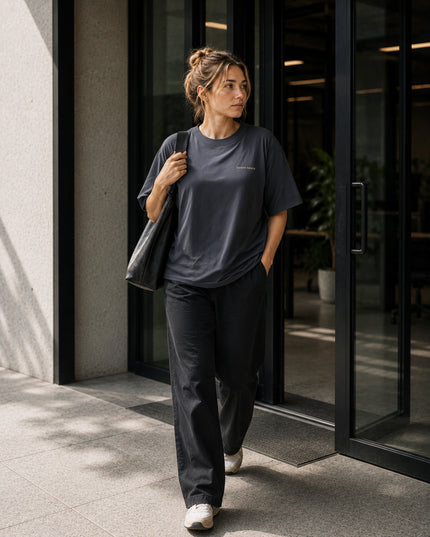 Female model wearing the Shevelo Latent space heavyweight oversized tee in Faded indigo.