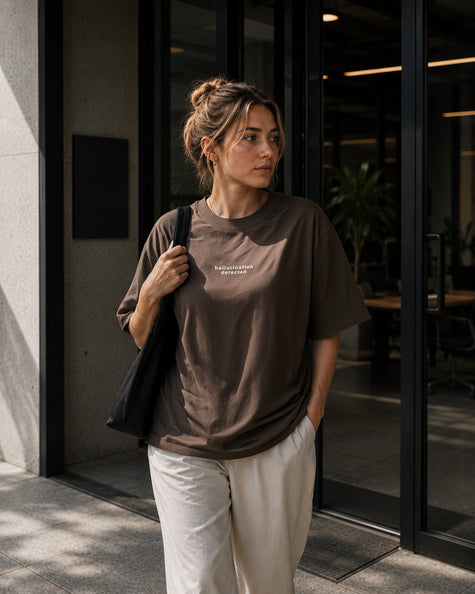 Female model wearing the Shevelo Hallucination detected heavyweight oversized tee in Faded brown.