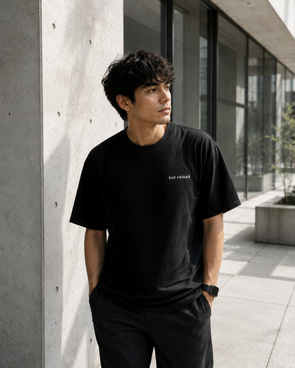 Male model wearing the Shevelo Hot reload heavyweight oversized tee in Faded black.