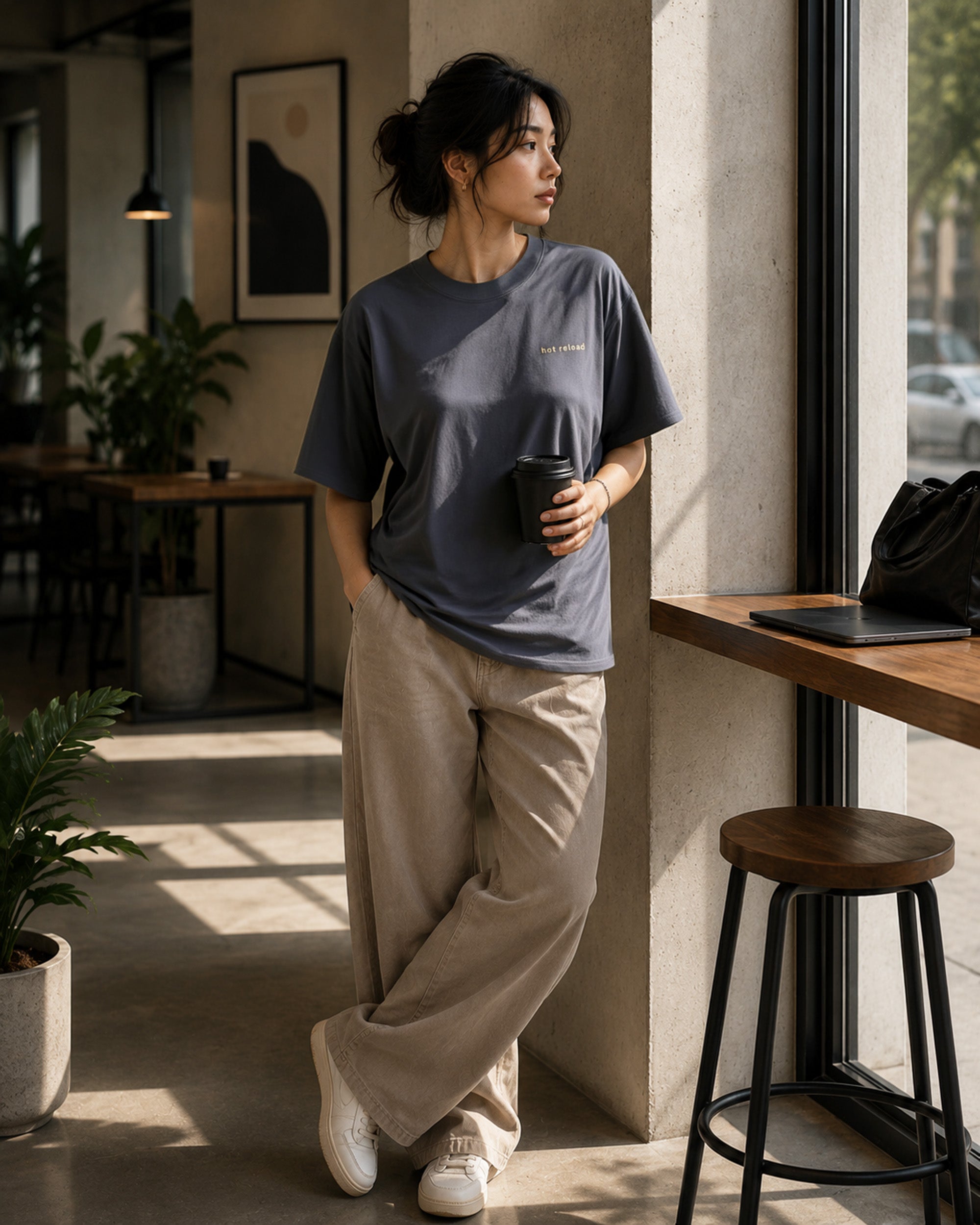 Female model wearing the Shevelo Hot reload heavyweight oversized tee in Faded indigo.