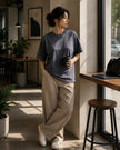 Female model wearing the Shevelo Hot reload heavyweight oversized tee in Faded indigo.