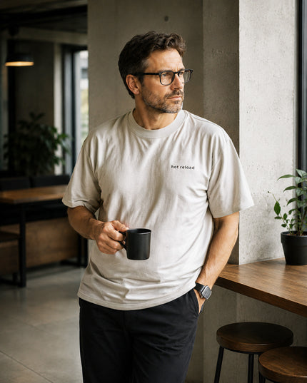 Male model wearing the Shevelo Hot reload heavyweight oversized tee in Faded Bone.