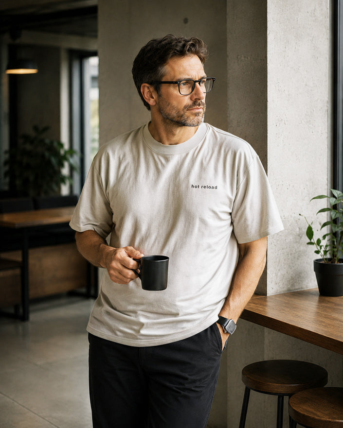 Male model wearing the Shevelo Hot reload heavyweight oversized tee in Faded Bone.