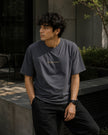 Male model wearing the Shevelo Merge conflict heavyweight oversized tee in Faded indigo.