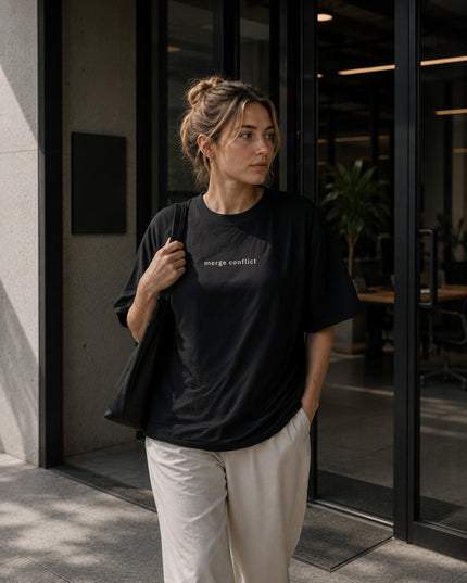 Female model wearing the Shevelo Merge conflict heavyweight oversized tee in Faded black.