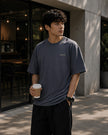 Male model wearing the Shevelo Localhost heavyweight oversized tee in Indigo.