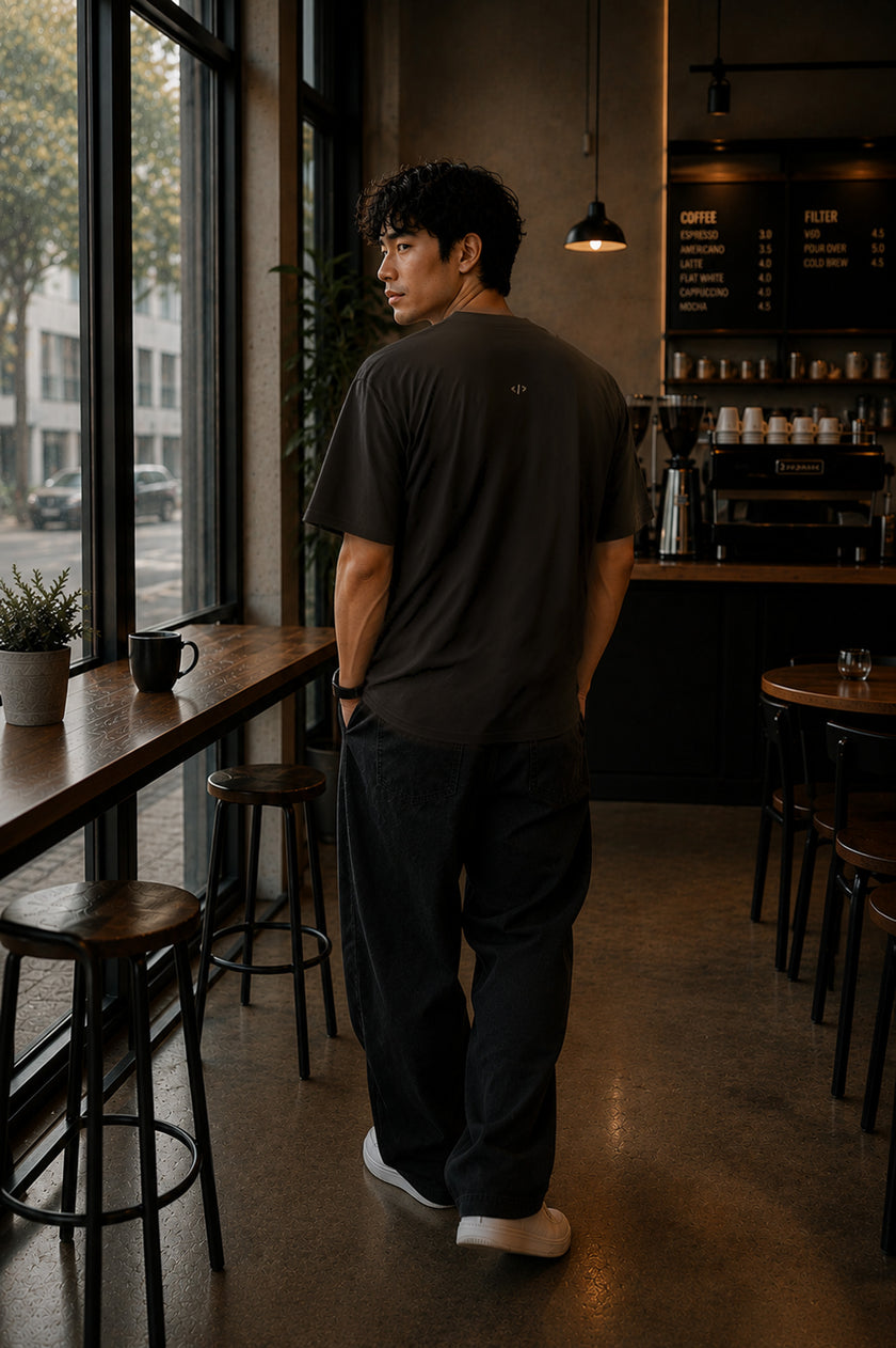 Rear view of the Shevelo Merge conflict heavyweight oversized tee in Faded black showing the signature back graphic.