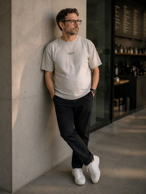 Male model wearing the Shevelo Runtime Error heavyweight oversized tee in Faded Bone.