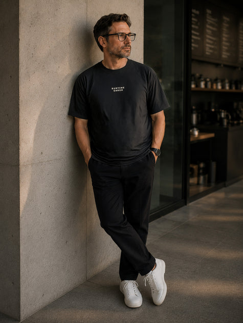 Male model wearing the Shevelo Runtime error heavyweight oversized tee in Faded black.