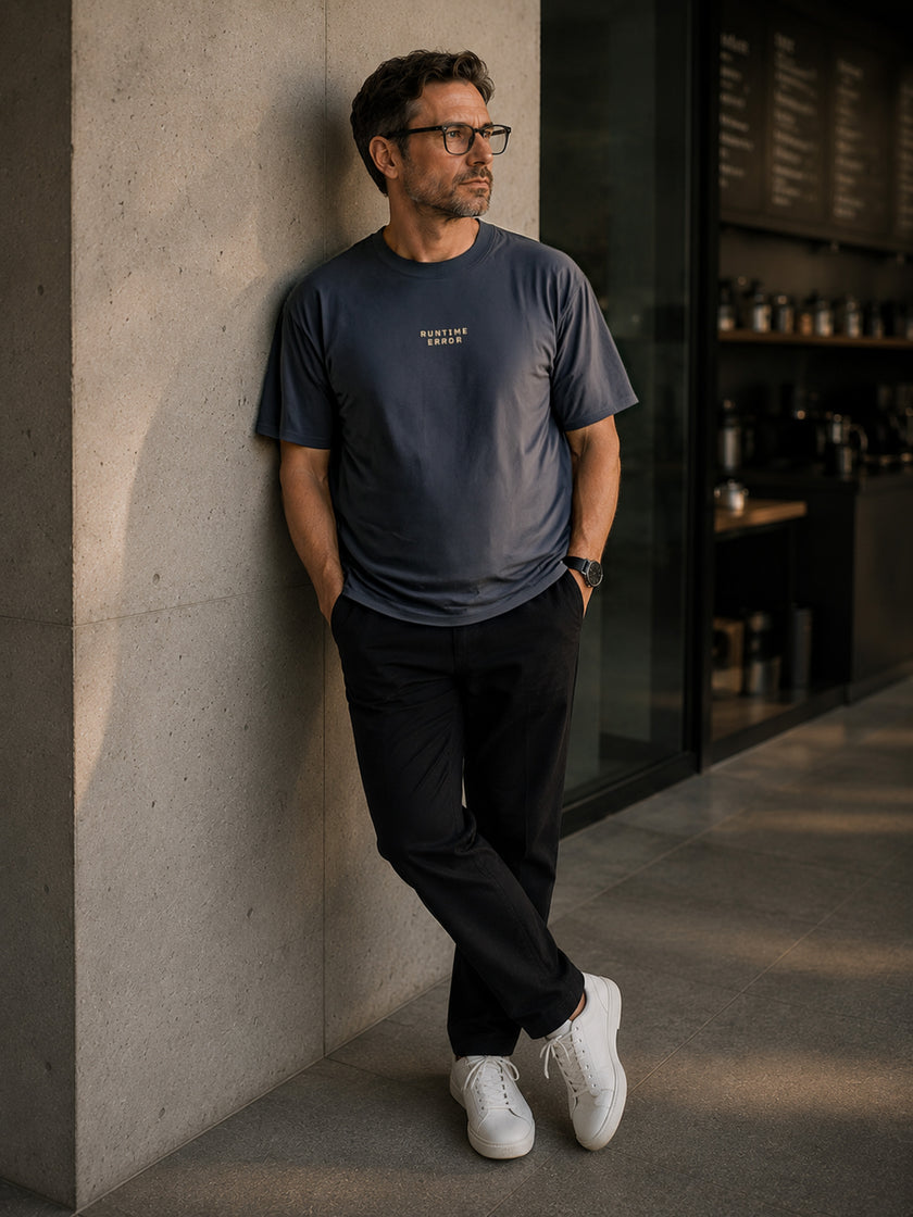 Male model wearing the Shevelo Runtime error heavyweight oversized tee in Faded indigo.