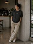 Female model wearing the Shevelo Context overflow heavyweight oversized tee in Faded black.