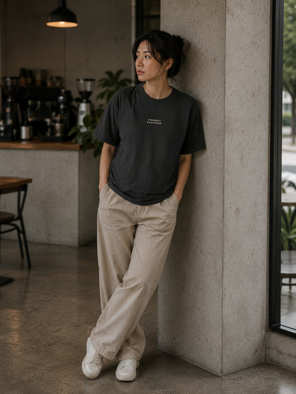 Female model wearing the Shevelo Context overflow heavyweight oversized tee in Faded black.