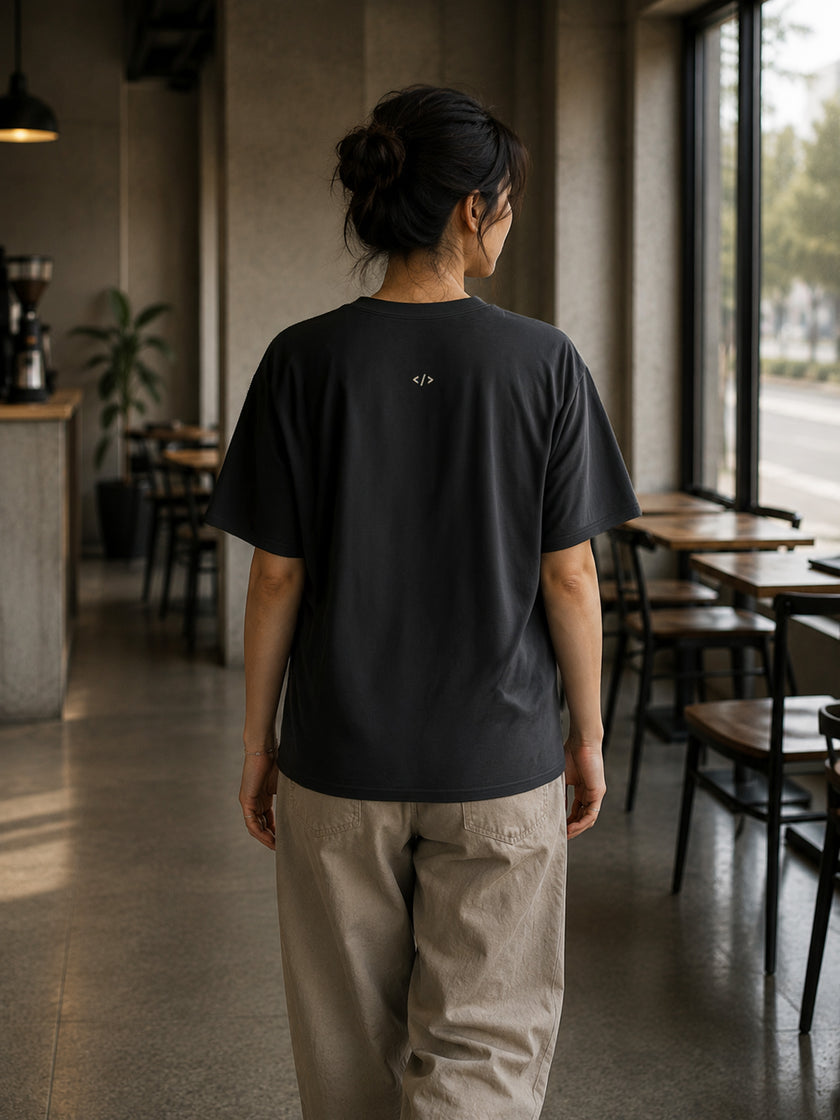 Rear view of the Shevelo Context overflow heavyweight oversized tee in Faded black showing the signature back graphic.