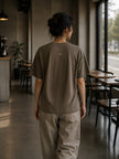 Rear view of the Shevelo Hallucination detected heavyweight oversized tee in Faded brown showing the signature back graphic.