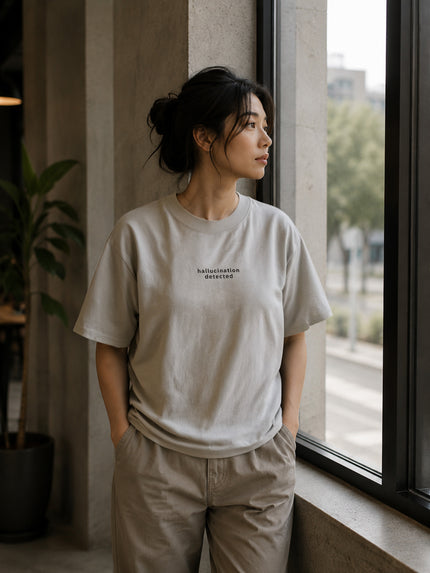 Female model wearing the Shevelo Hallucination detected heavyweight oversized tee in Faded Bone.