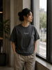 Female model wearing the Shevelo Hallucination detected heavyweight oversized tee in Faded black.