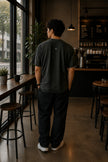 Rear view of the Shevelo Hallucination detected heavyweight oversized tee in Faded black showing the signature back graphic.