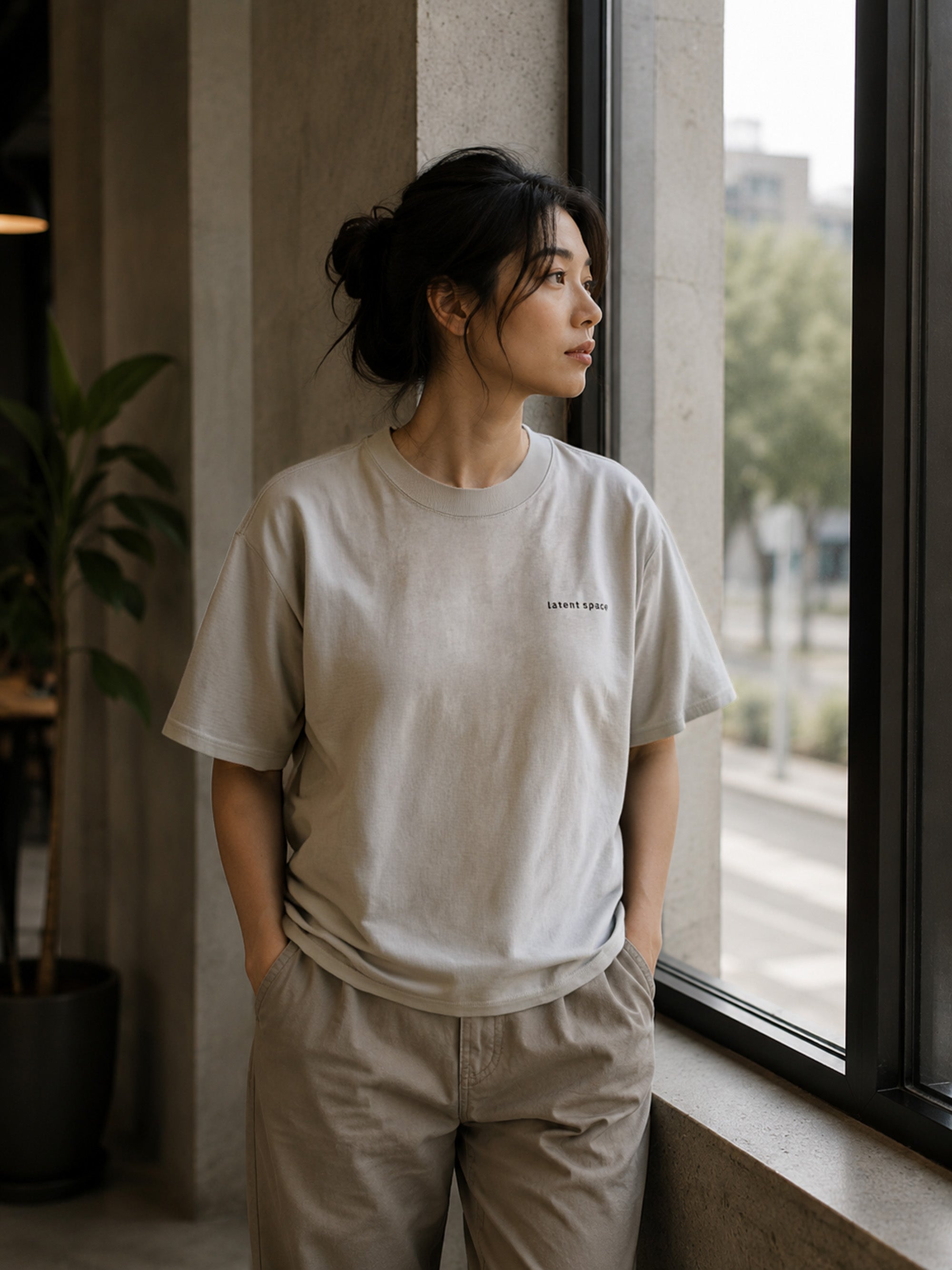 Feale model wearing the Shevelo Latent space heavyweight oversized tee in Faded Bone.