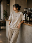 Female model wearing the Shevelo Token limit heavyweight oversized tee in Faded bone.